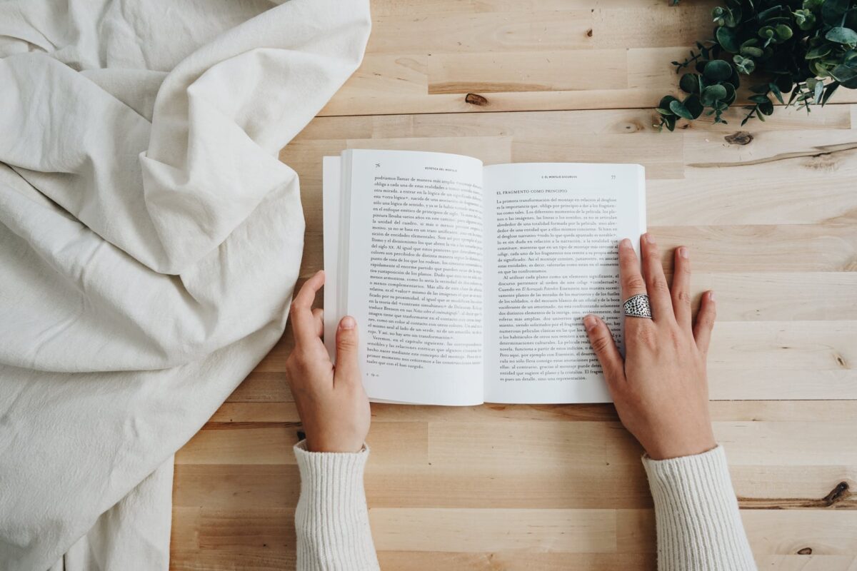 photo of person holding a book